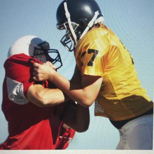 What type of behavior is demonstrated by the football players in the picture?  a conflict reso