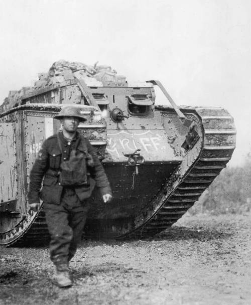 I need help, please!! so the question is: An American soldier walks ahead of a British-made tank in