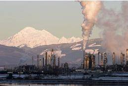 The image shows an oil refinery in Washington.

Which best explains how this refinery is affecting