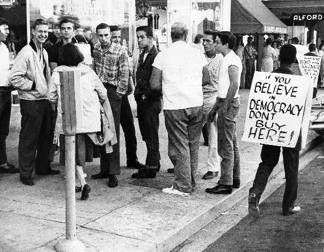 The image shows protestors participating in nonviolent resistance during the civil rights movement.