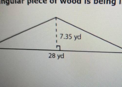 A triangular piece of wood is being installed on a front porch. The piece of wood is shown below. F