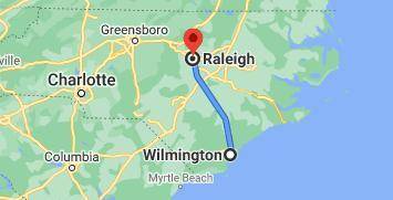 The scale on the second map is 1 cm to 50 km. The actual distance from Charlotte to Wilmington is 3